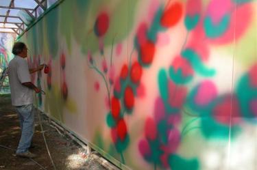 Claude Guit&eacute; repainting a part of the Printemps mural