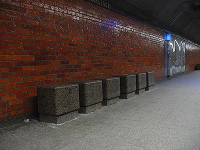 Seats and red brick at platform level