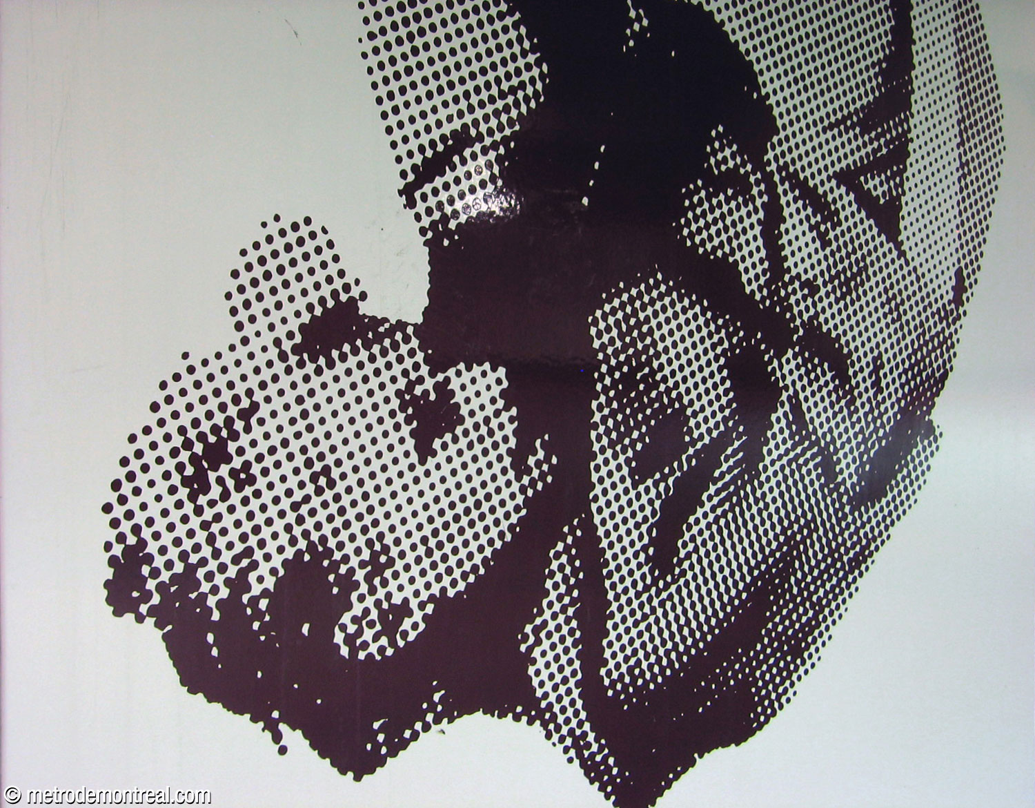 Detail of one of Jean Mercier's murals, showing the photographic Ben Day dots printed on the white enamel background.