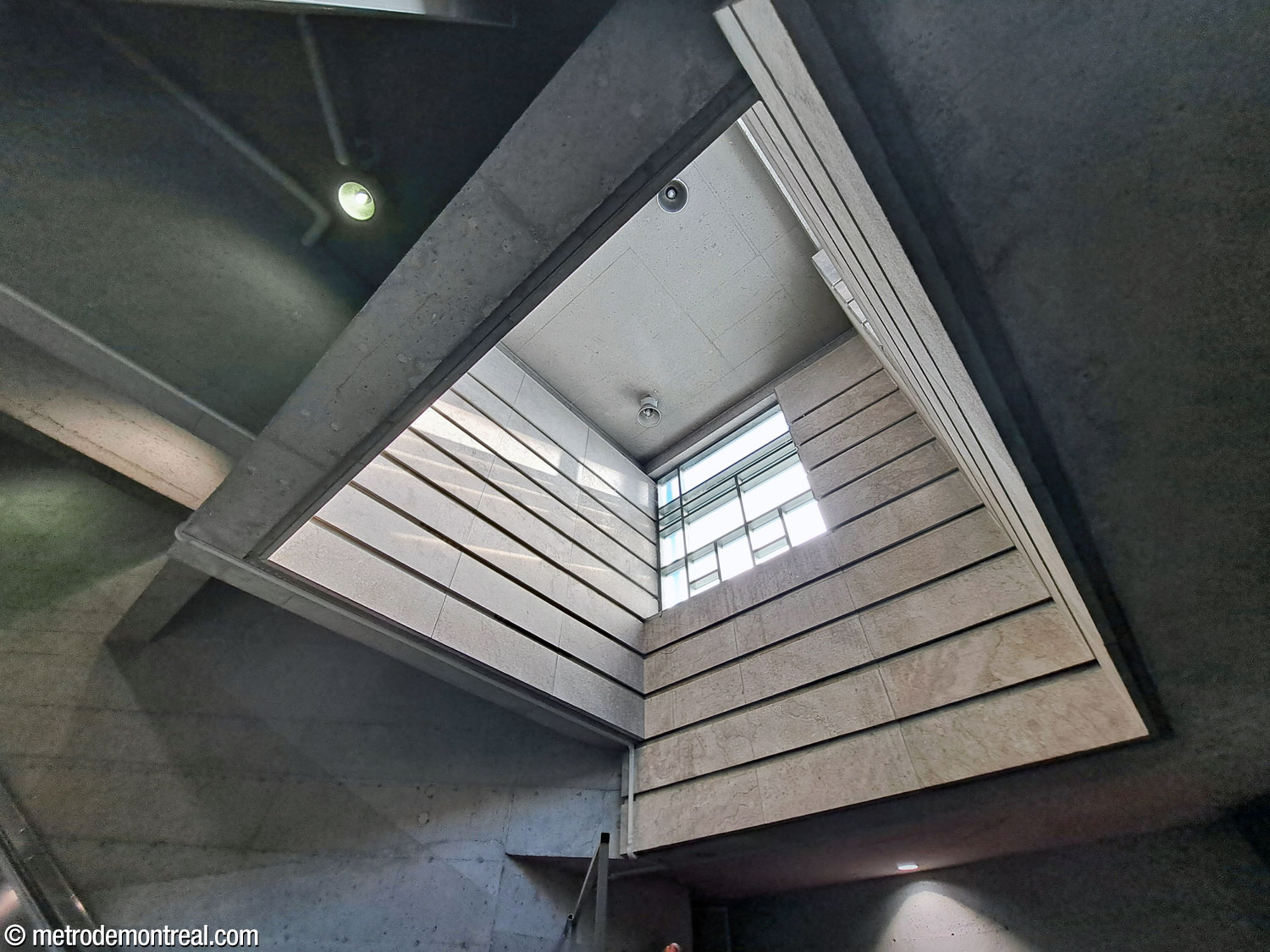 The light shaft over the landing at the foot of the stairs to the Beaumont headhouse. The shaft is clad in pale limestone panels and occupies the western tip of the headhouse.