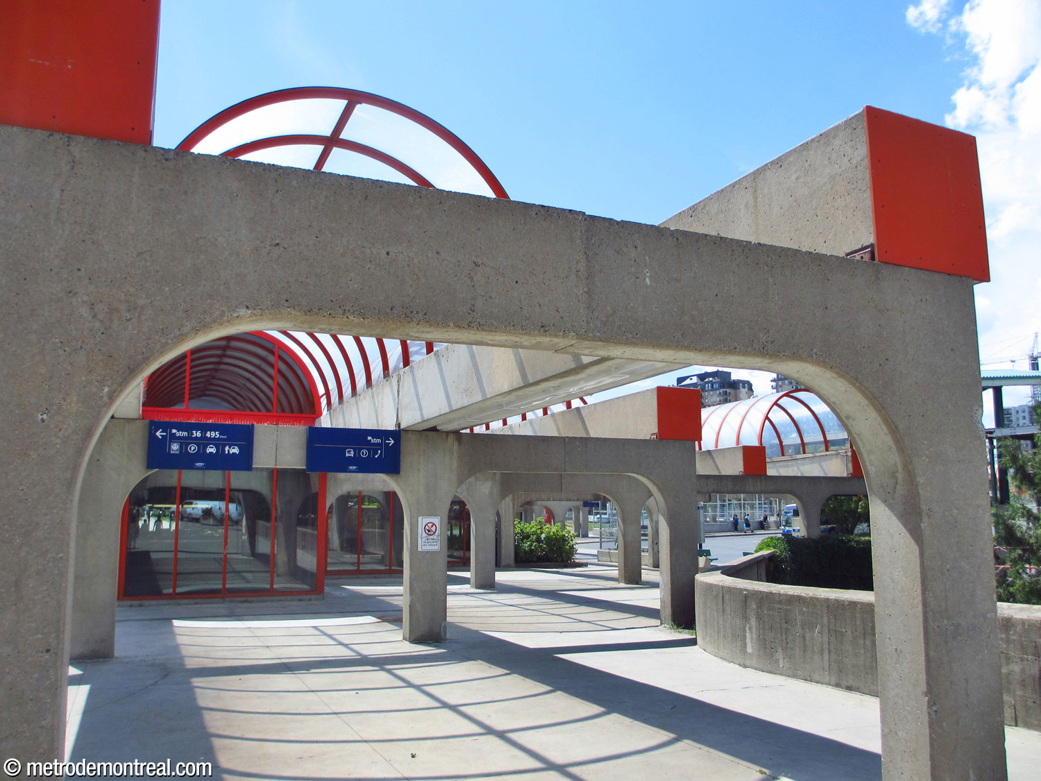 Arcade and domed overhangs on the northeast façade. The bus terminal is seen on the right.