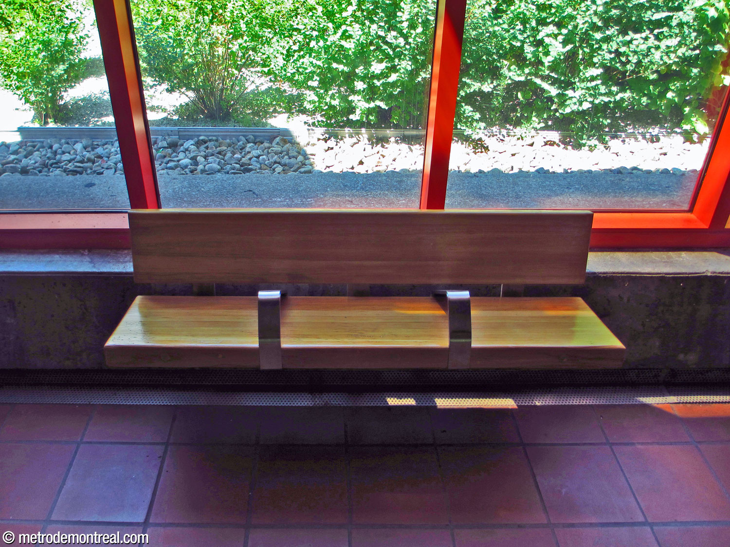 One of the wooden platform benches, with the platform-level windows behind.