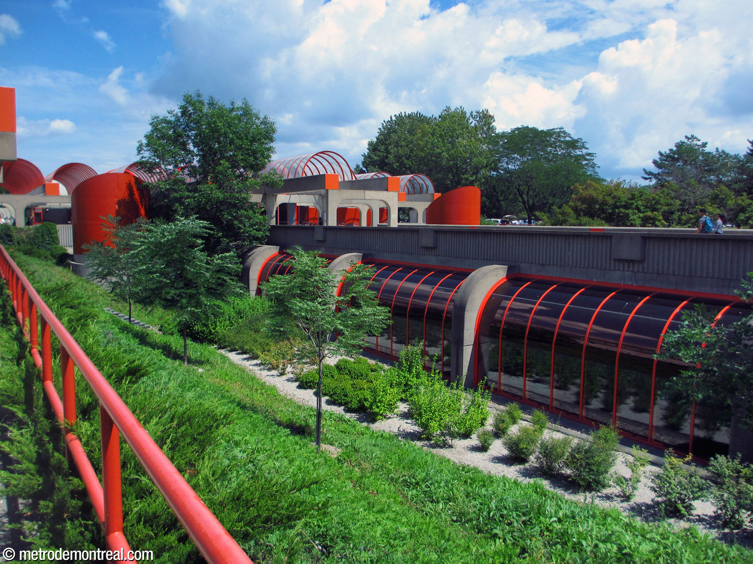 Exterior view of the platform windows, showing the landscaped slope leading down to platform level.