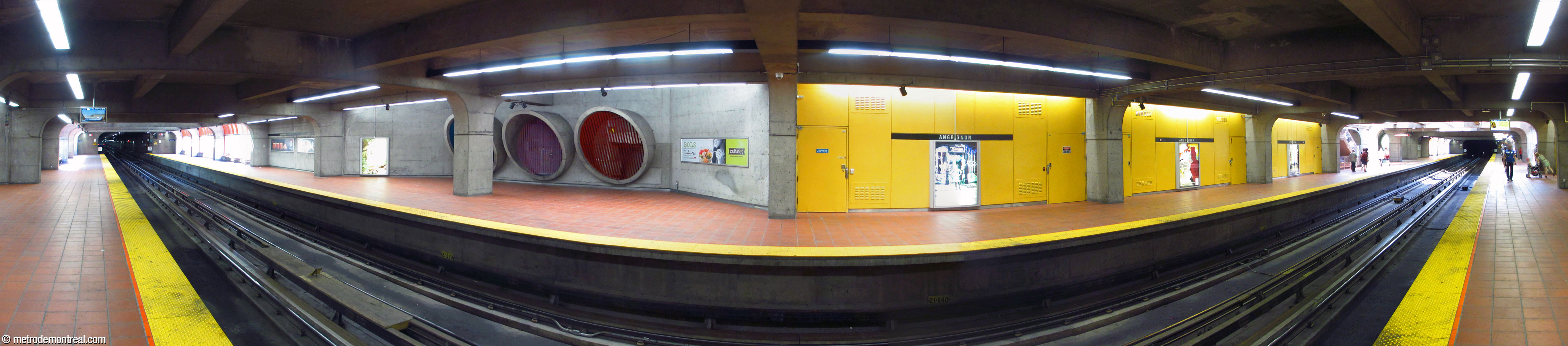Panorama of the Angrignon terminus platform seen from the Honoré-Beaugrand platform. While the platform ends are flooded with daylight, the central section is brightened by the lemon-yellow wall panels and brightly coloured ventilation shaft grilles.