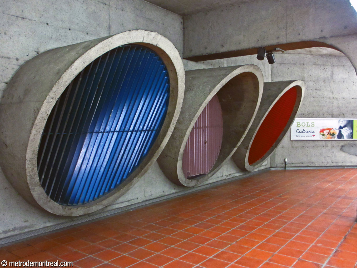 Blue, mauve, and red grilles on the imposing ventilation outlets at the centre of each platform.