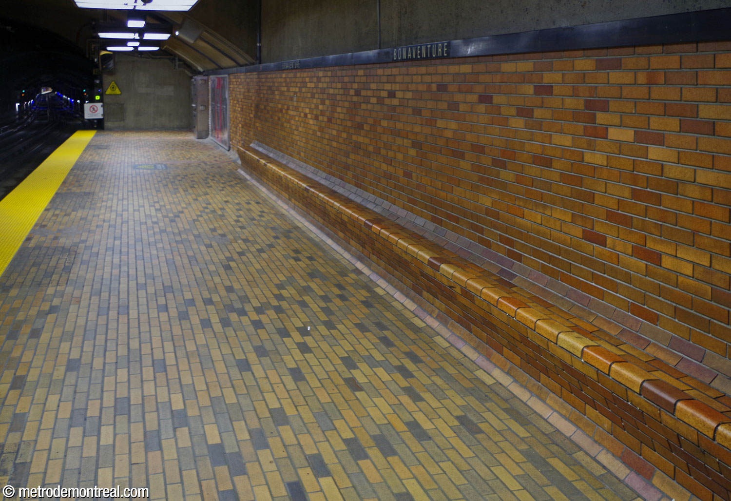 Le briquetage en terre cuite qui pare les murs du quai, ainsi que leurs bancs intégrés.