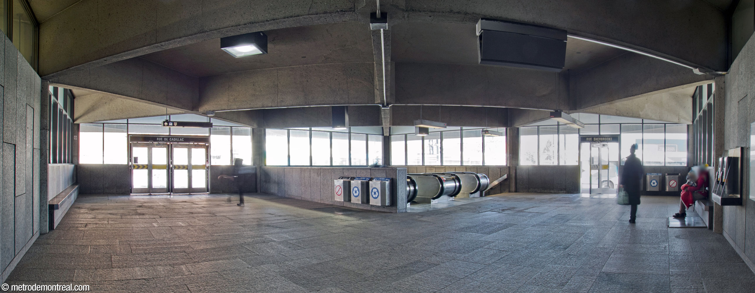 Interior of the Sherbrooke Sud headhouse. Notice the square diamond-shaped roof coffers, the windows along the full length of the façades, and the granite panels with integrated benches along the back walls.