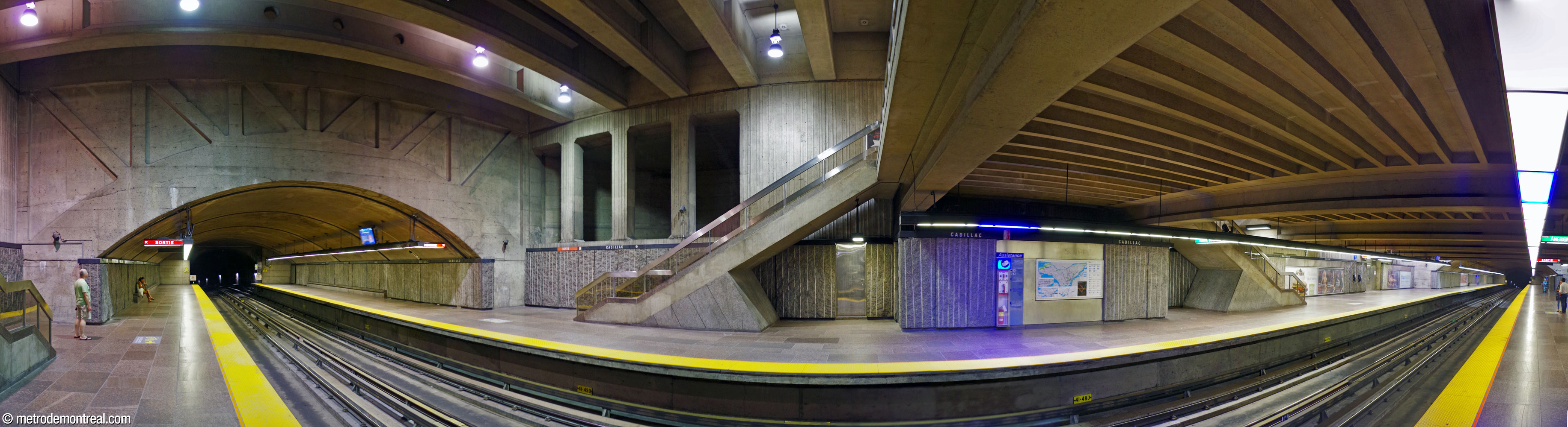 The station's main volume, showing the dramatic forms of the staircases, ventilation shaft, and spandrel wall.