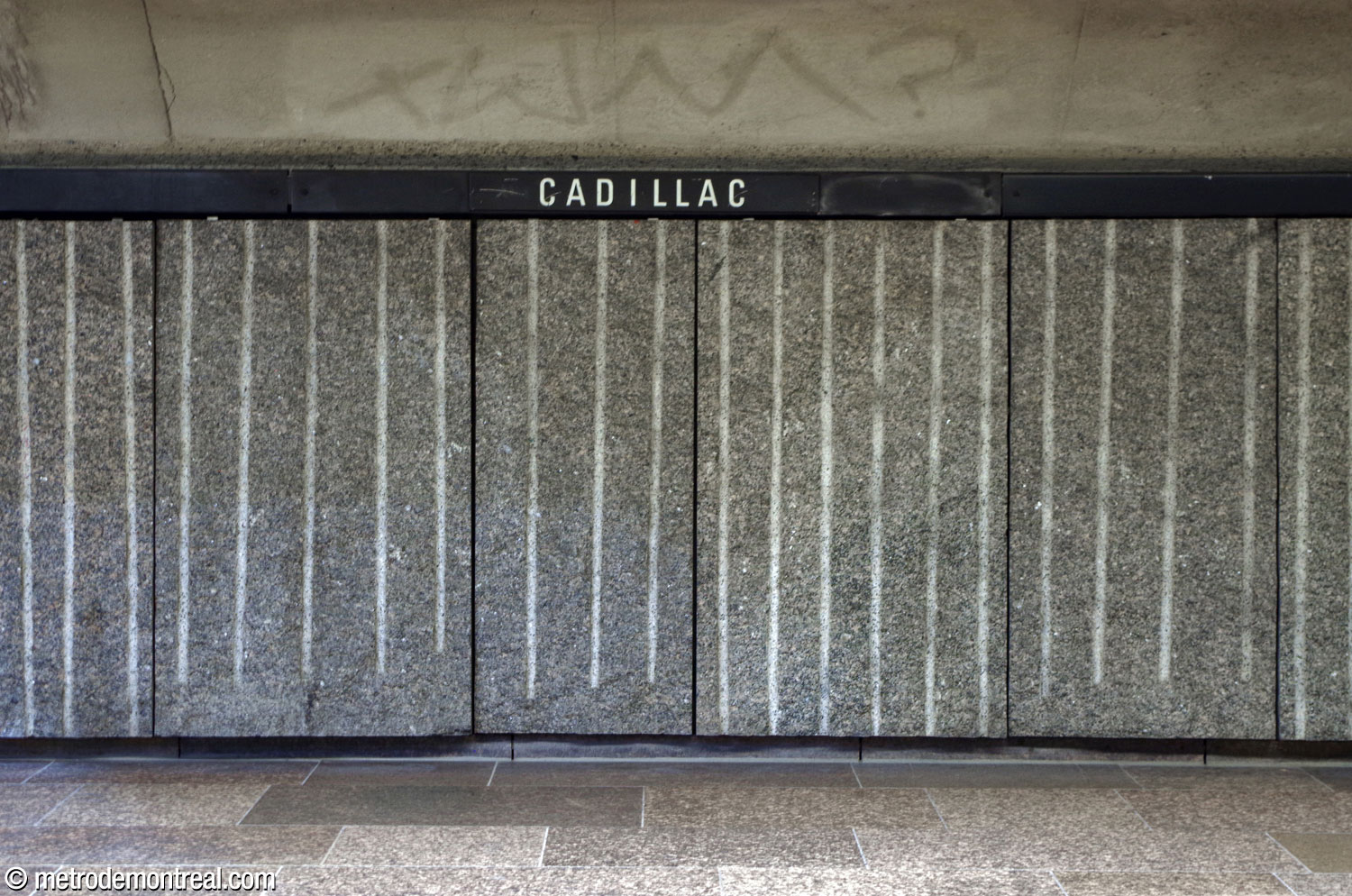 The rough, grooved granite panels that line the platforms and access hallways.
