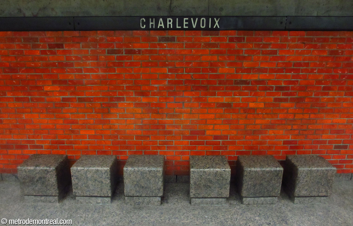 The red brick walls and granite block seats at platform level