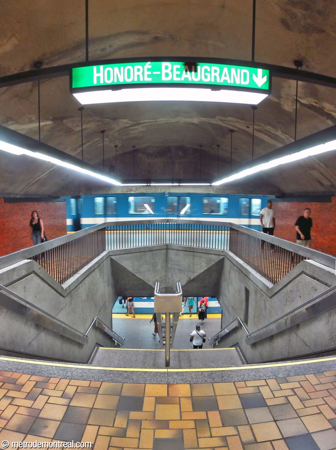 Two trains pass at the upper and lower platforms.