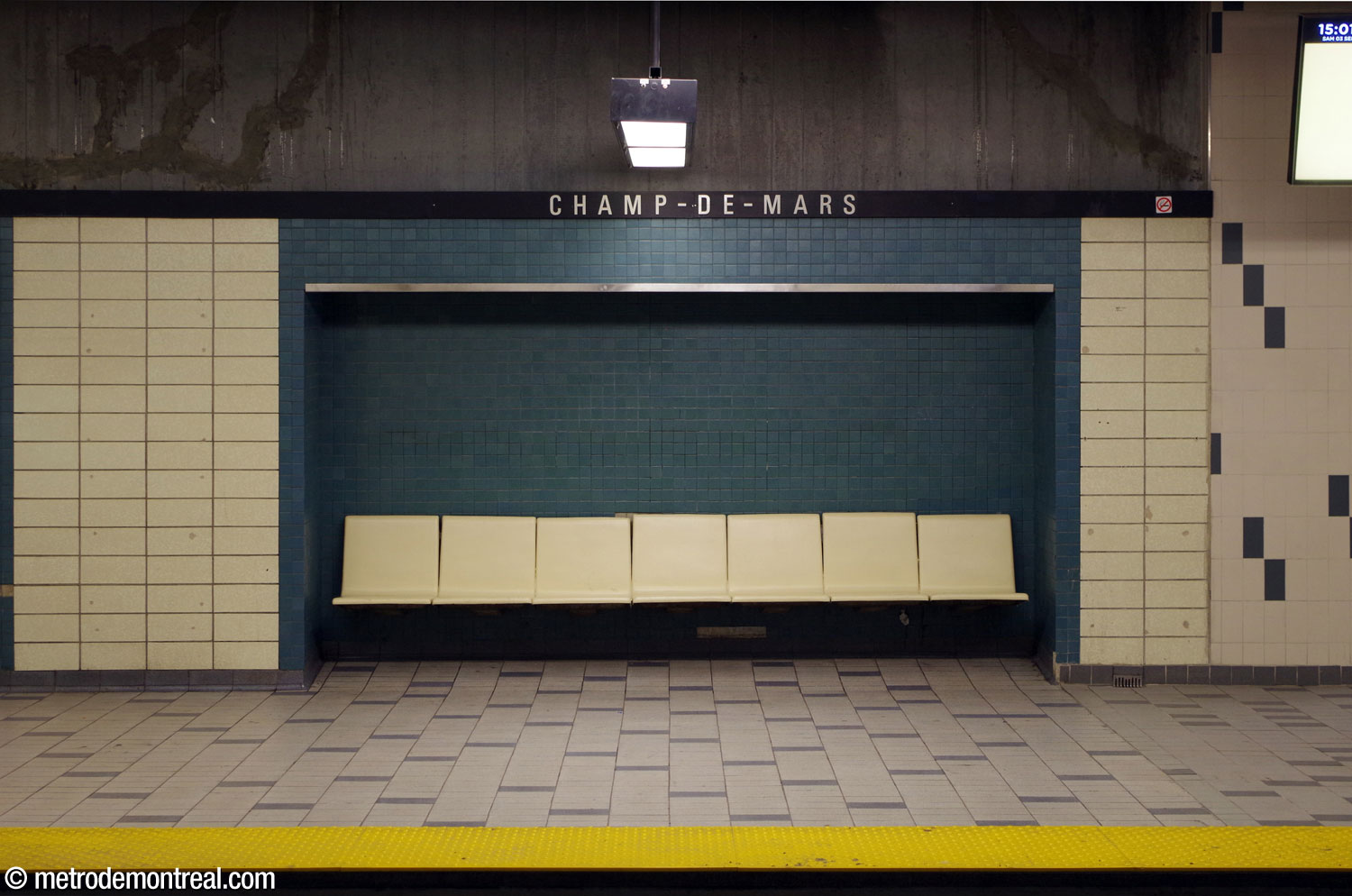 Cream-coloured fibreglass platform seating in an alcove lined with blue-green tiles.