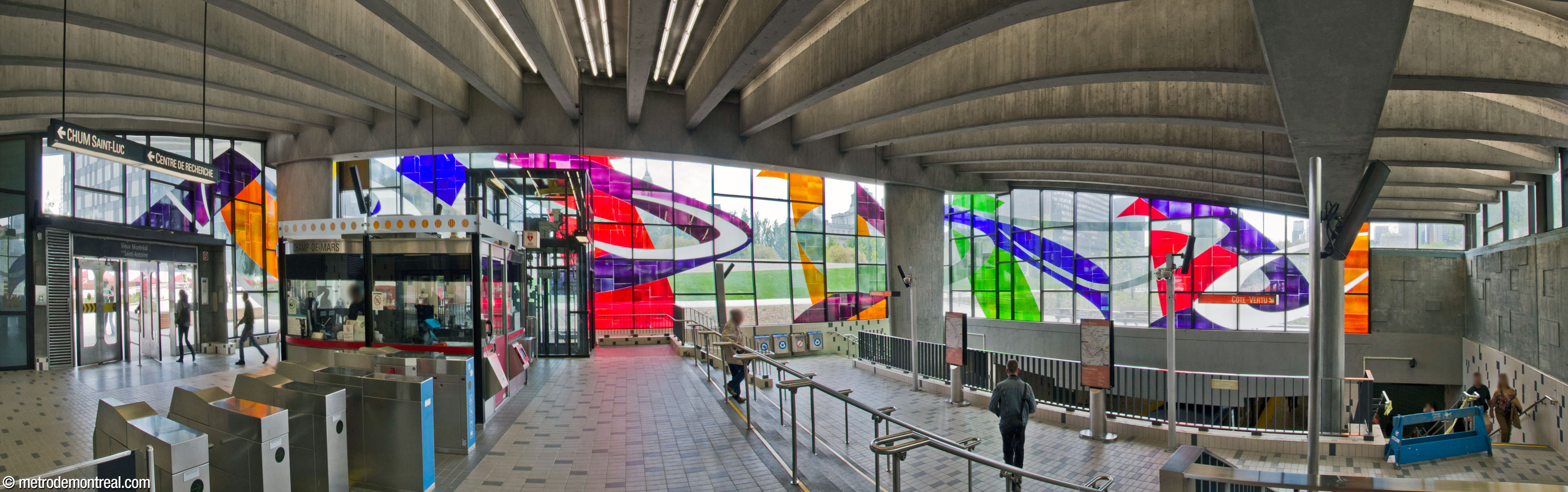 Panorama of the interior of the headhouse, with the stained-glass window by Marcelle Ferron on the east, south, and west walls. The roof is angled upward to receive the sun, and the concrete beam ceiling is supported at its four corners by large oval columns.