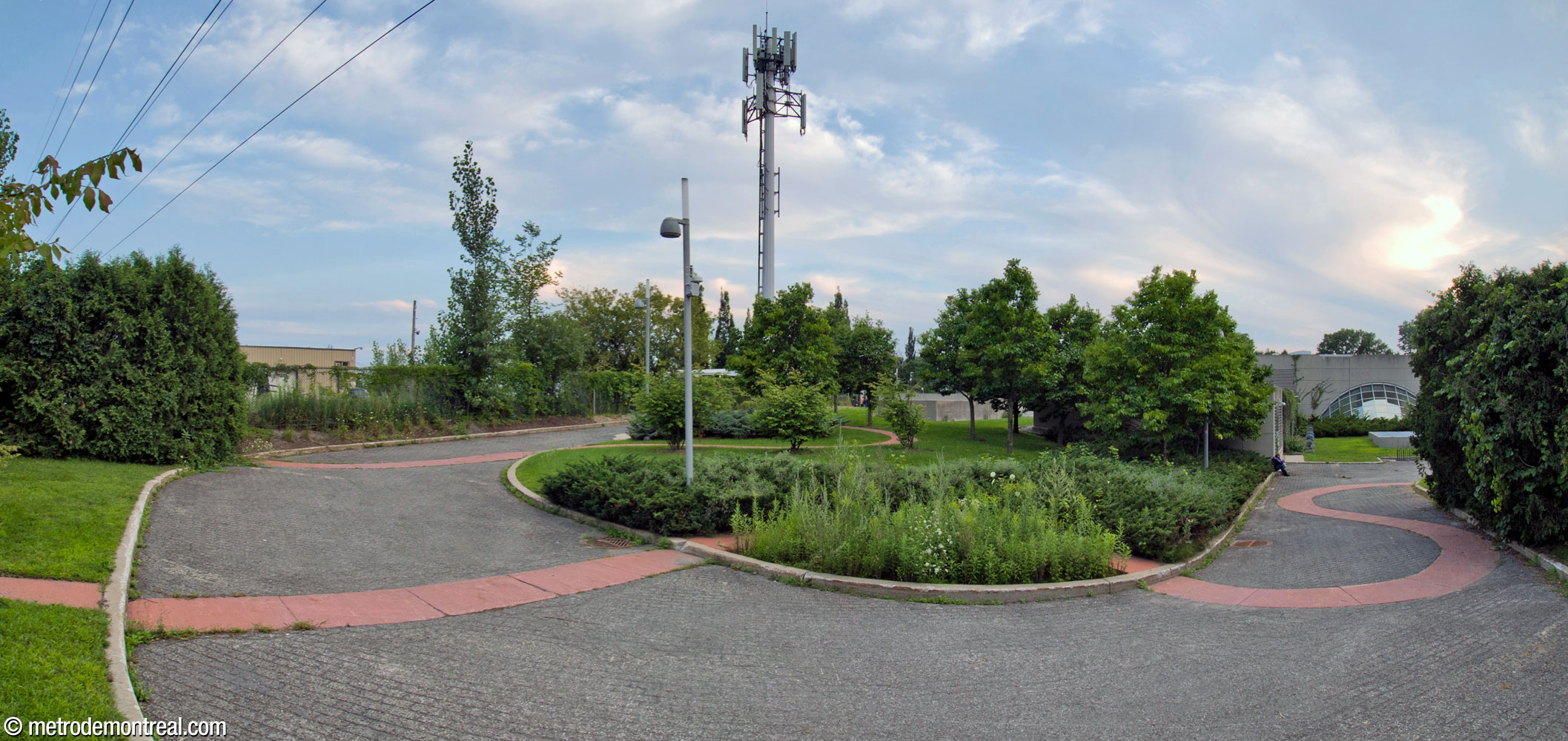 The landscaped garden and walkway east of the station headhouse. The landscaping is interlaced with a sinuous path of pink slabs.
