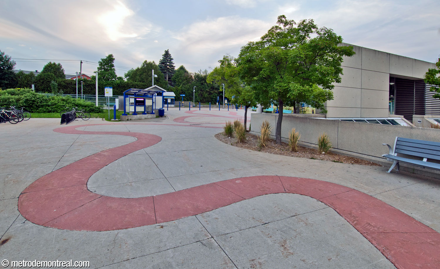 The path of pink slabs continues onto the plaza behind the headhouse leading to the commuter train station.