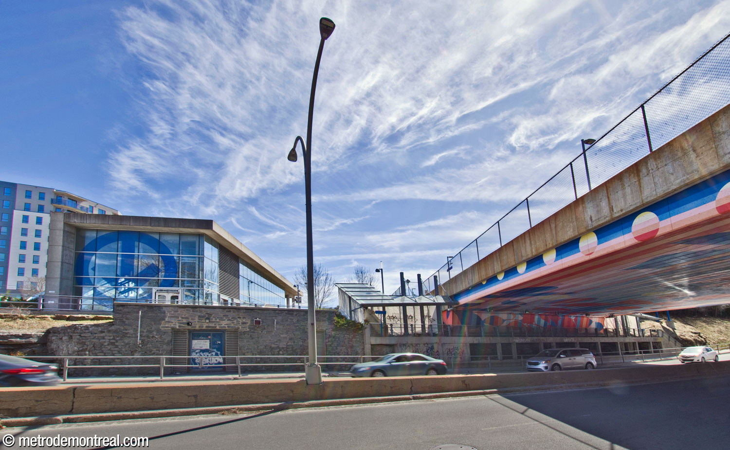 View of the walkway between the headhouse and the train station's western platform, passing under the viaduct that hosts the train station.