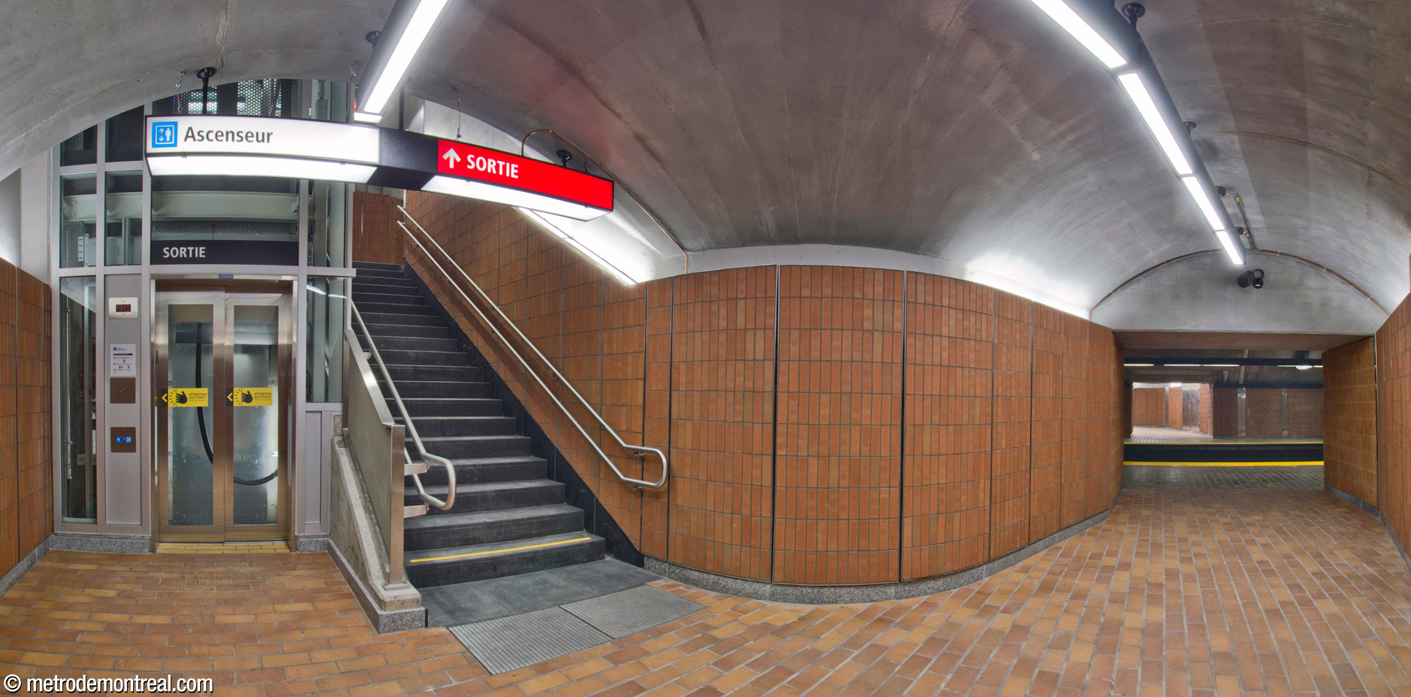 The bottom of the elevator to the Snowdon platform, housed in a vaulted alcove outboard of the platform. Beside the elevator, an additional stairwell was added for evacuation safety, to avoid creating a dangerous dead end.