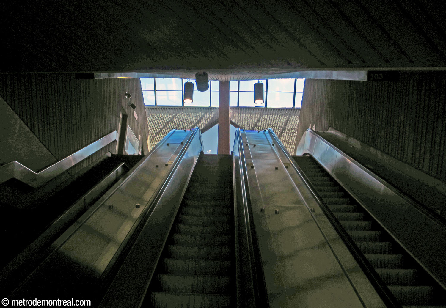 Escalators from the mezzanine to street level, with a view of the headhouse skylight.