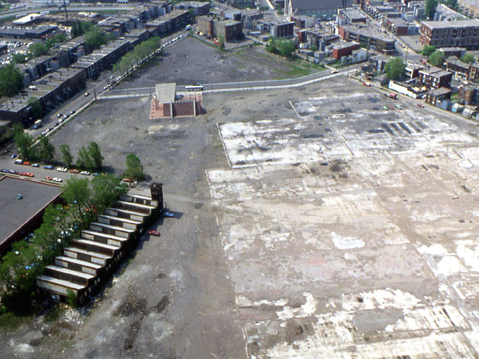 Aerial view of the station soon after its construction, following the demolition of the main factory buildings. The area would soon be redeveloped into a residential neighbourhood. The smaller factory at lower left still stands and has been converted to residential use.