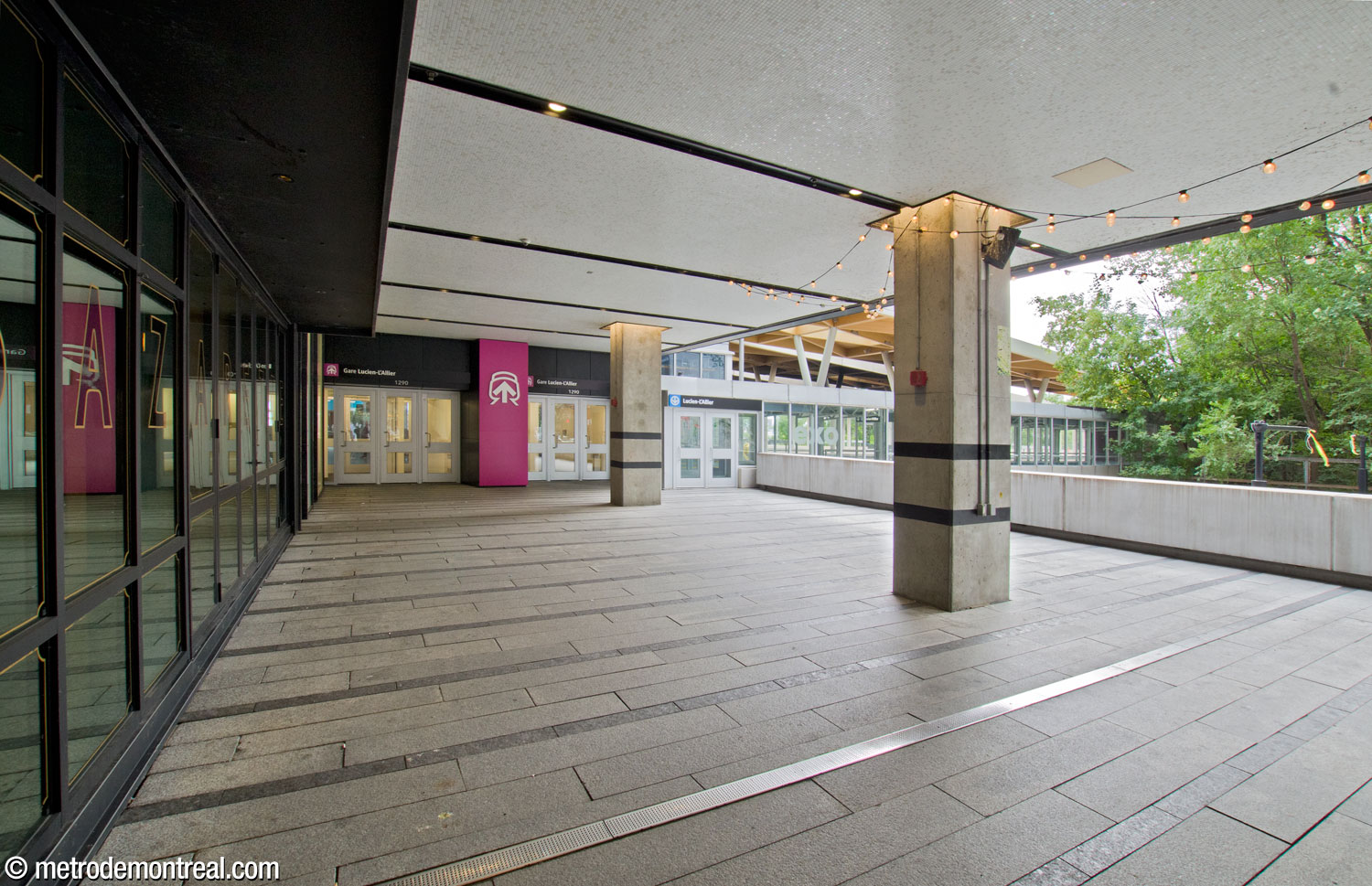 Entrance to the commuter train station, obscured underneath the overhang of the condominium tower. At right, Rue de la Montagne passes under a viaduct which carries the station tracks and the passage to the metro station.