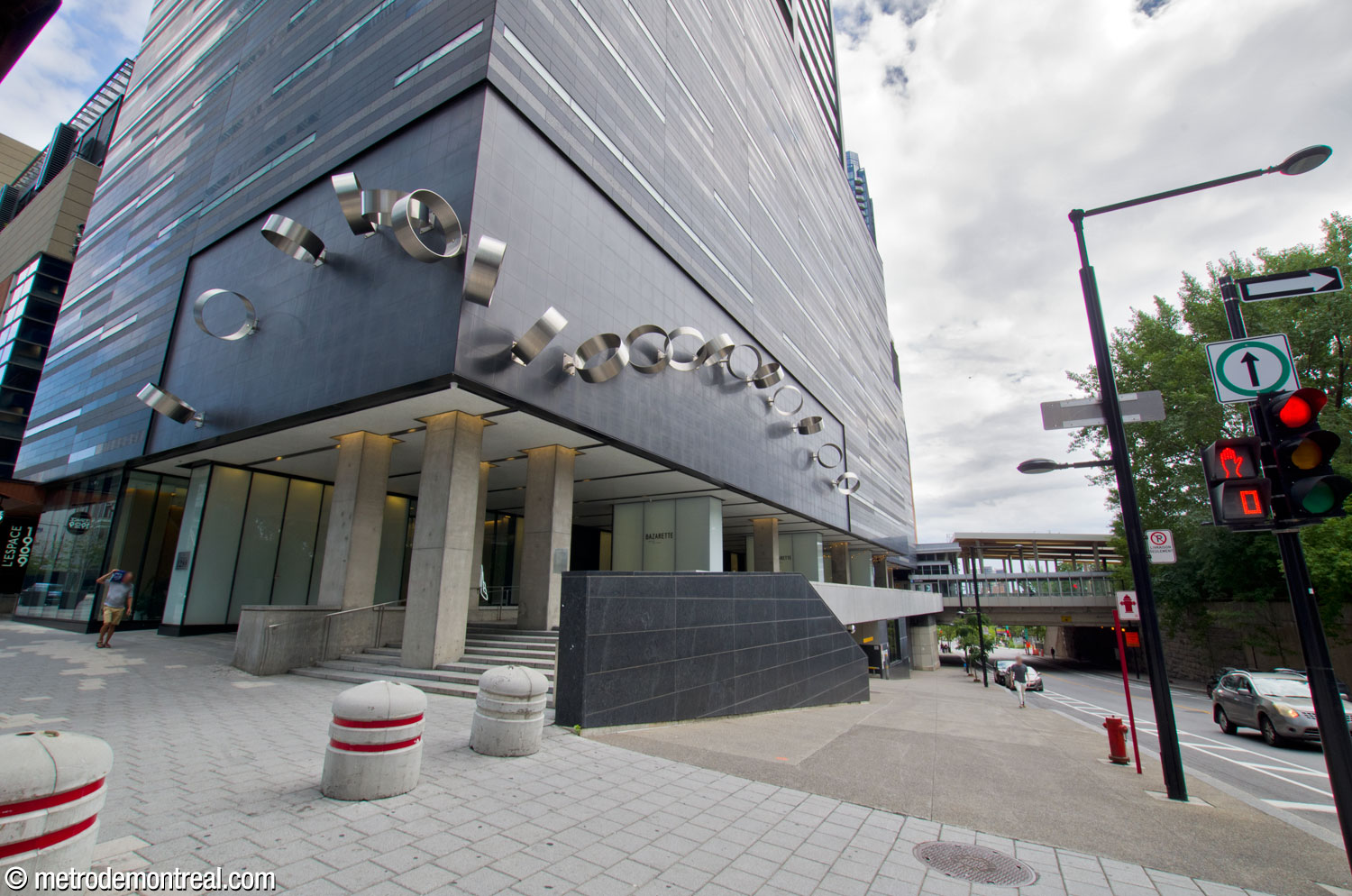 The forecourt of the commuter train station is now occupied by a condominium tower, obscuring the presence of the station, which is not indicated by any signage.