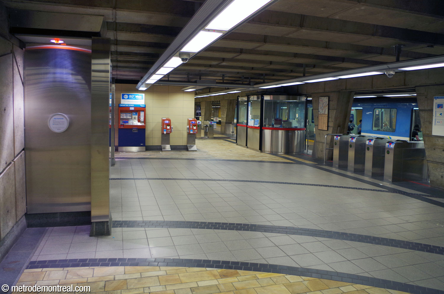 The eastern end of the ticket hall, with a train standing at the platform.