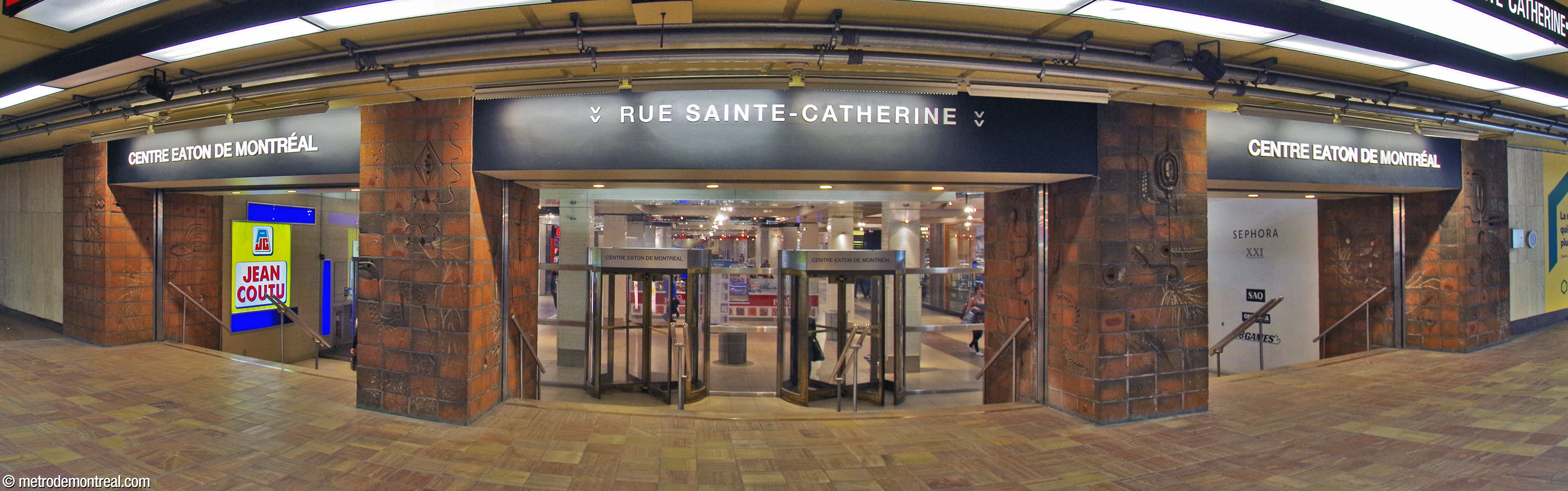 The four sets of terra cotta reliefs by Maurice Savoie, surrounding the eastern entrance to the Centre Eaton.