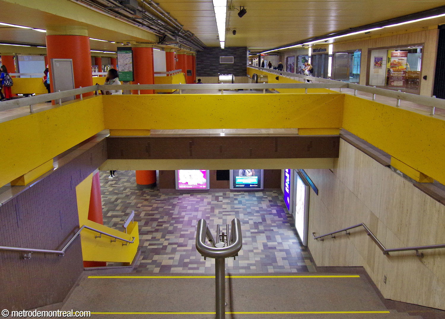 The easternmost staircase to the Angrignon platform, with, in the background, the second flight of stairs between the eastern ticket hall and the platform.