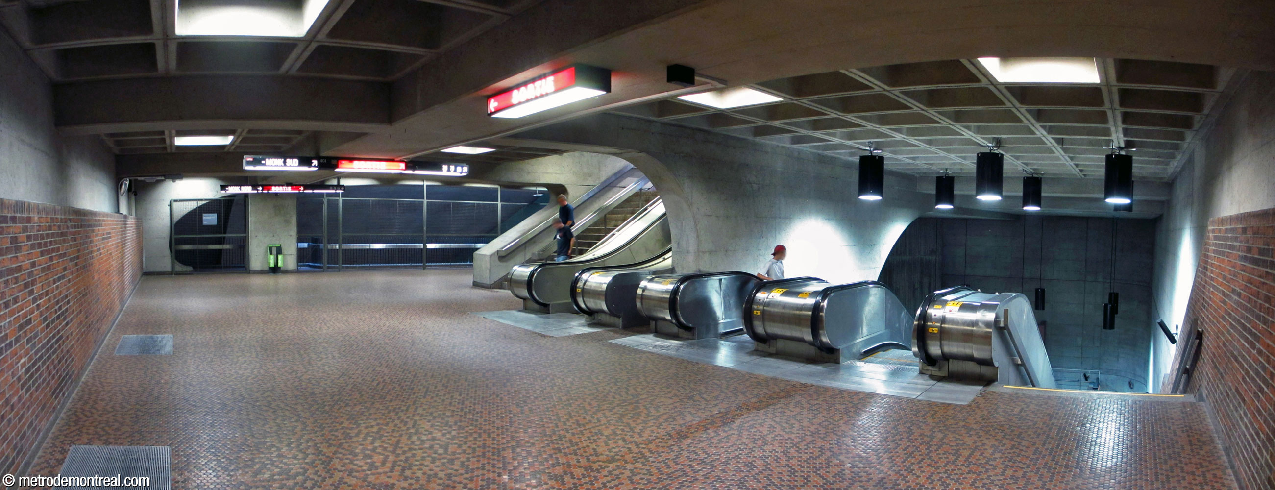 The landing at the head of the escalators leading down to the ticket hall. This landing is at the foot of the staircase from the Monk Sud entrance and the end of the walkway leading to the Monk Nord entrance.