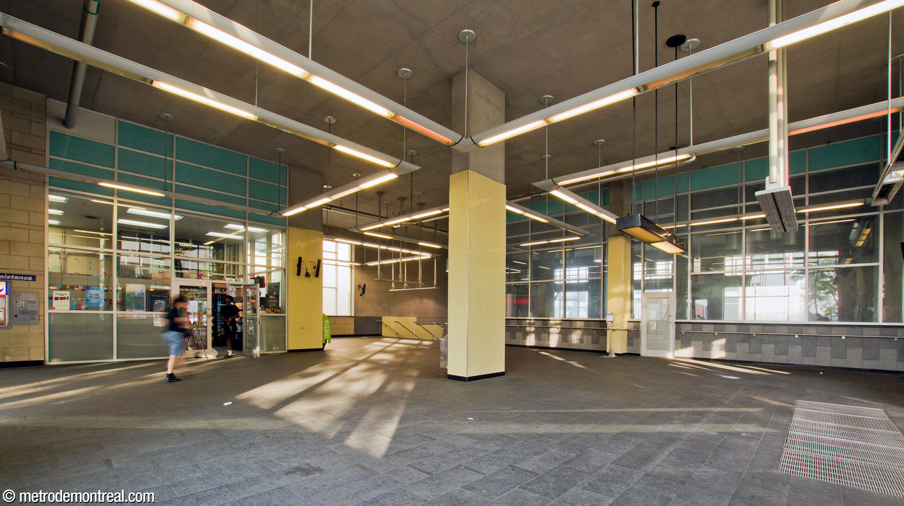 The interior of the metro headhouse, looking toward the stairwell down into the station (centre). The glass surface at right overlooks the concourse and the main stairwell to the ticket hall.