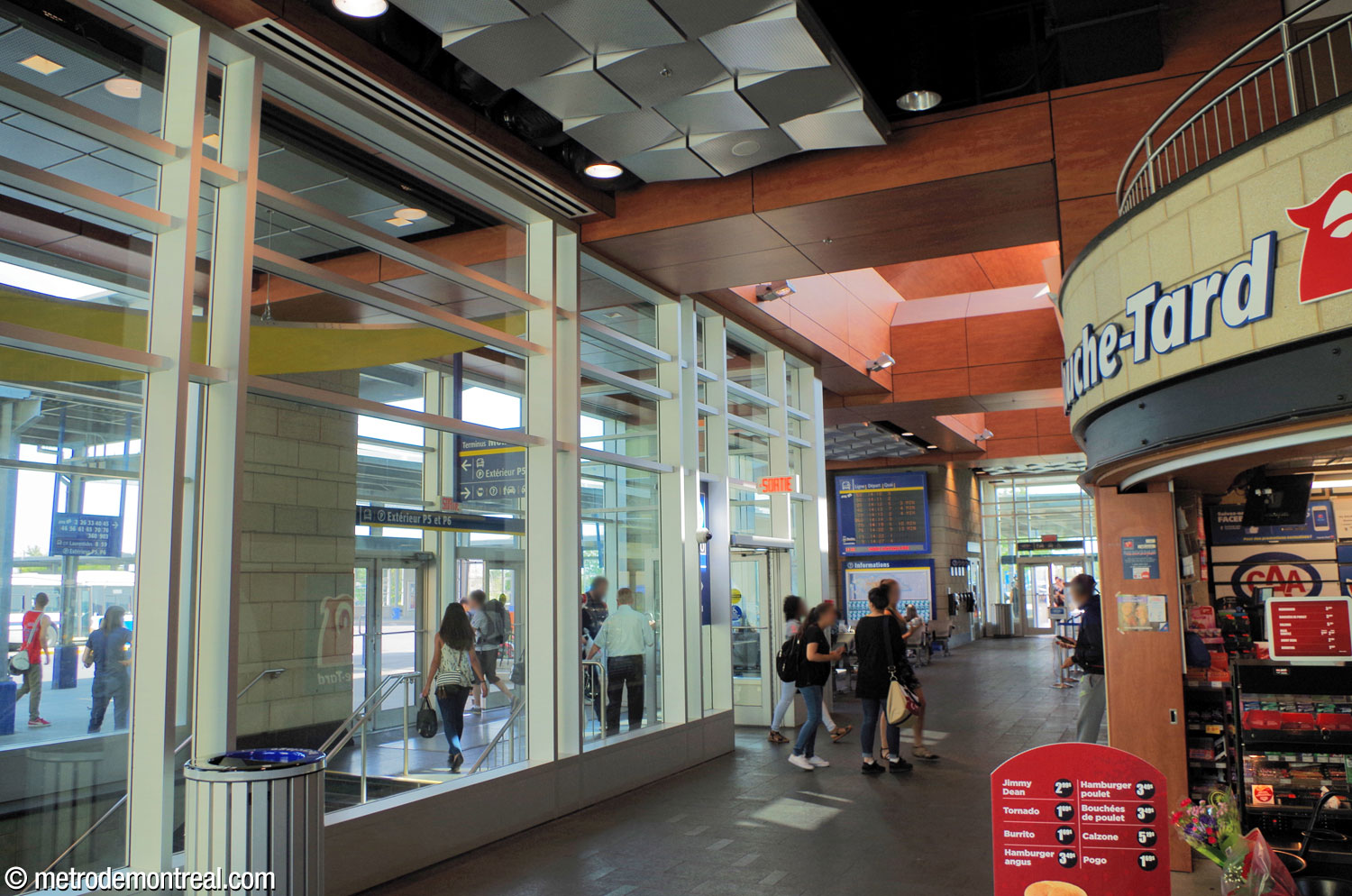 The hallway from the main entrance leads into the waiting area of the bus terminal building. The enclosed area at left leads to the exit toward the terminal platforms and to the staircase down to the metro station.