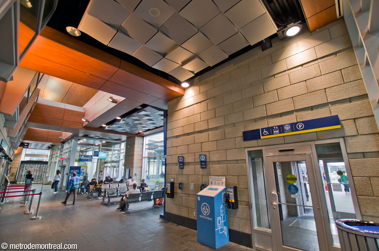 The bus terminal waiting area seen from its south end. Ticket windows and concessions are at left; at right are elevators to the parking garage and metro station, and an additional exit toward the terminal platforms.