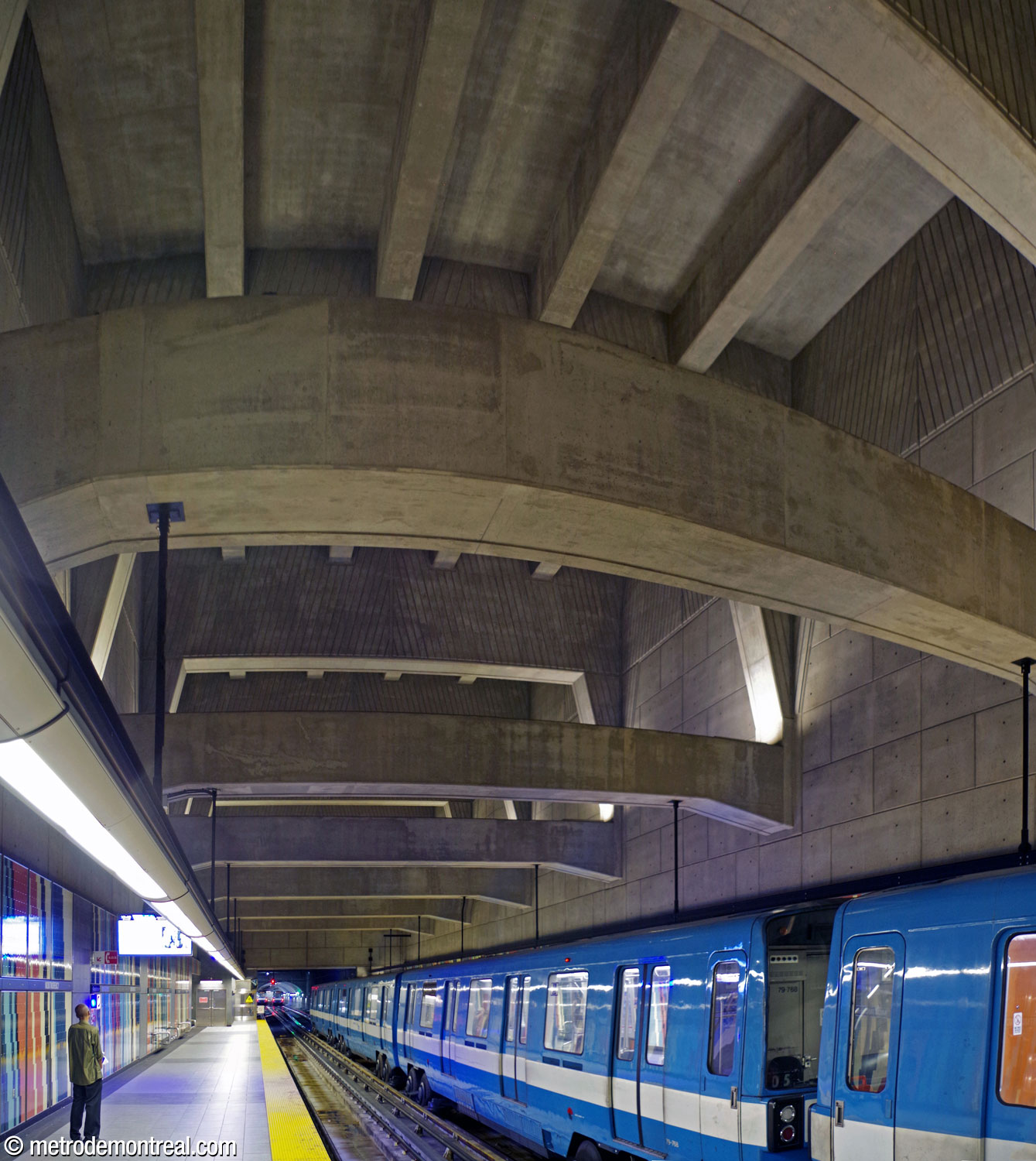 The trainroom's deep volume and huge cross-braces loom above the platforms.