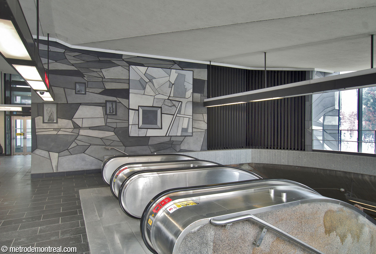 A section of Simon Bilodeau's mural Je reviens chez nous, on a west-facing wall in the headhouse, above the original stairwell. The large inset represents a map of the Plateau early in its settlement. The small section adjacent to the window, right, depicts one of Montreal’s famous spiral staircases.