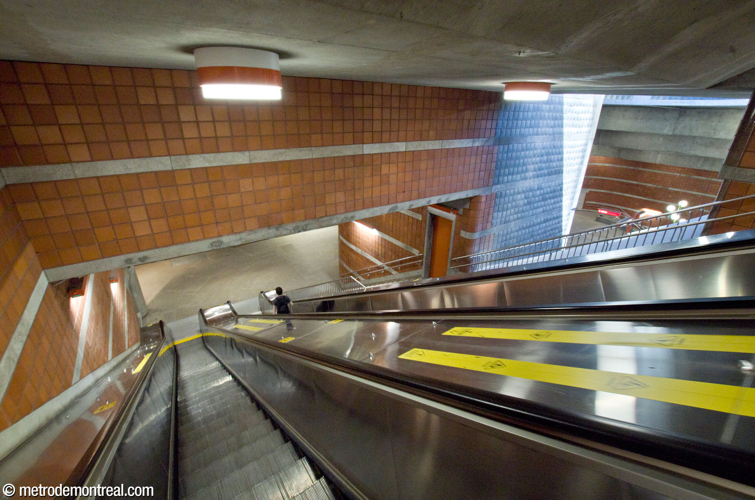 Midway down the main stairwell; the overlook onto the light shaft and main volume is at right.