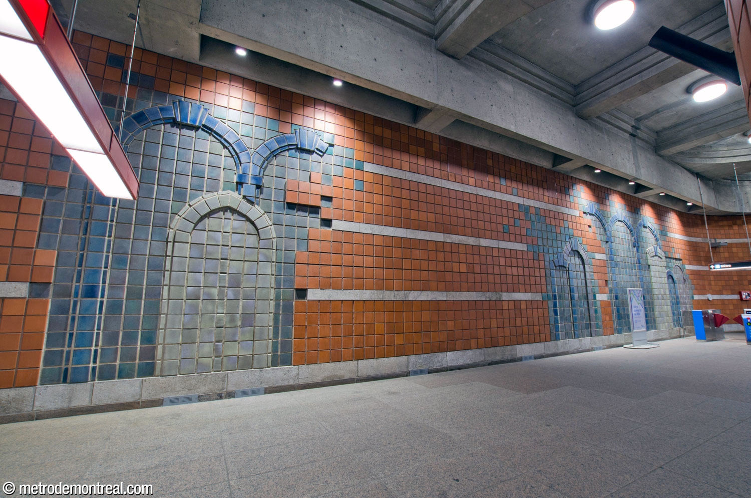 Overview of the different sections of Gilbert Poissant's mural spanning the width of the rear wall of the ticket hall.