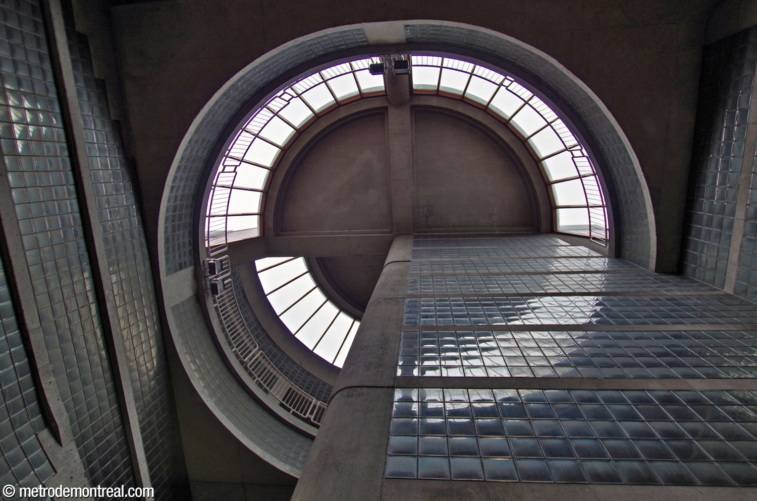 Looking up the light shaft to the large round lantern that crowns it. A quarter circle section is raised above the others.