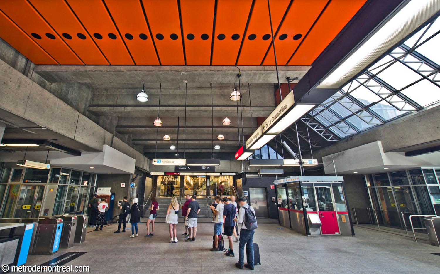 L'extrémité ouest du hall et l'entrée vers le Palais des congrès. À droite, on voit l'une des loges des agents de station, séparée des barrières de perception. Les ascenseurs vers les quais se trouvent de ce bout du hall.