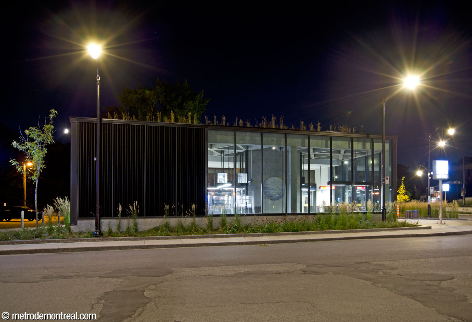 Exterior view of the eastern façade of the Place Saint-Henri headhouse at night. The upper section of Rives scintillantes by Véronique La Perrière M looks out onto the street.