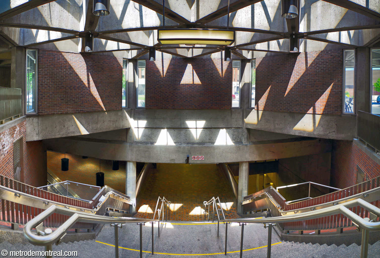 The stairwell descending from the Saint-Ferdinand headhouse to the concourse, with the large skylight above it.