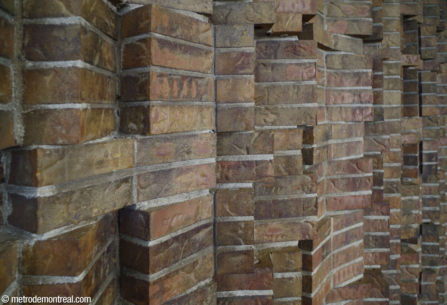 Detail of Mario Merola's brickwork relief Rivières, in the Berri Ouest entrance.