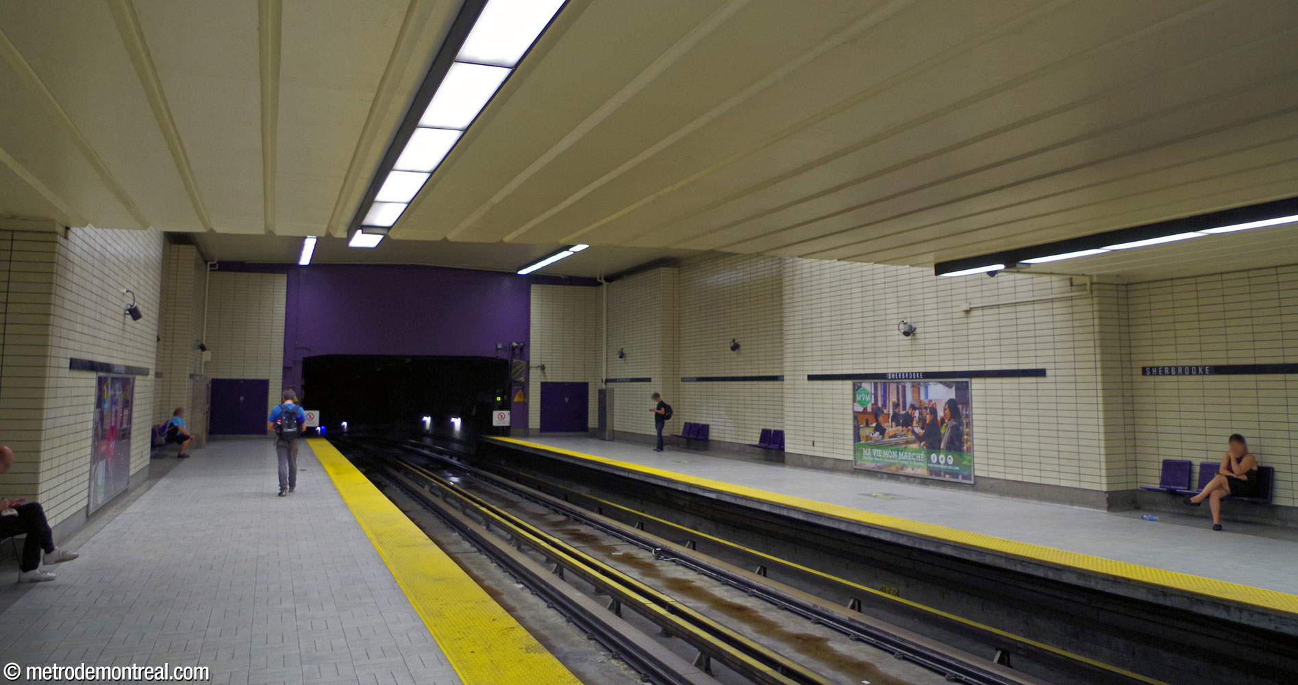 The south end of the trainroom, seen from the Montmorency platform. The spandrel over the tunnel mouth is accented in purple.