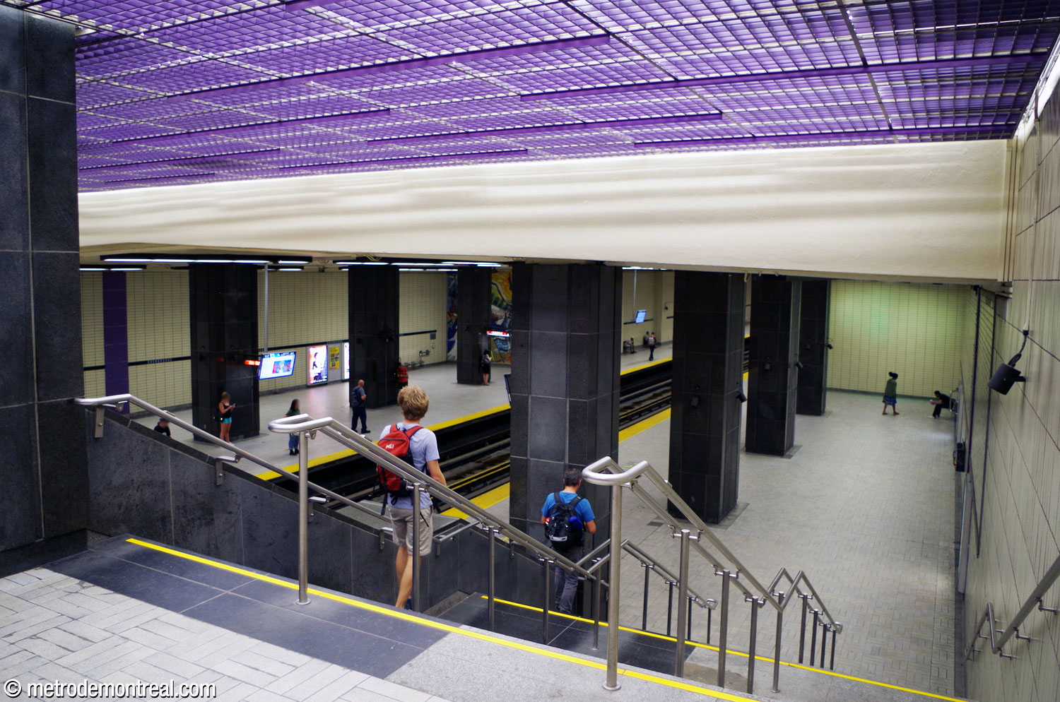 The broad staircase down from the mezzanine to the side aisle along the Montmorency platform.