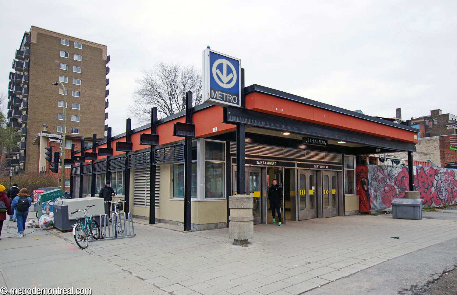 The station's single headhouse, a small structure with a flat overhanging roof supported by outboard steel beams.