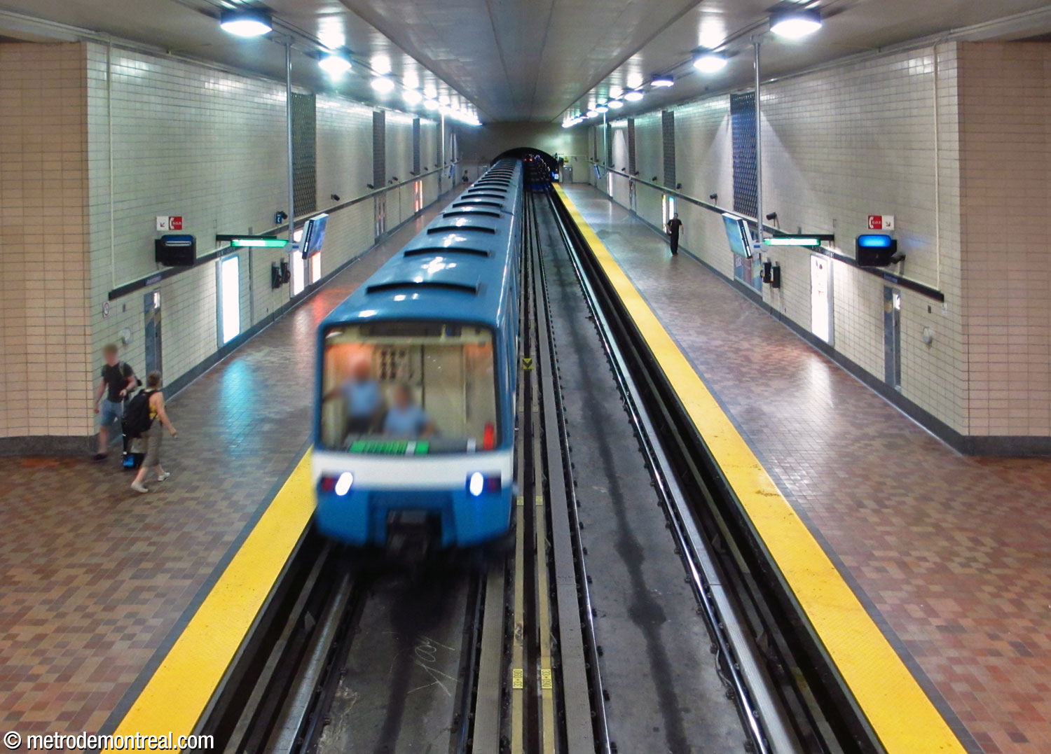 The volume over the eastern half of the station, seen from the mezzanine. The ceramic murals by Claude Vermette line the upper parts of the platform walls.