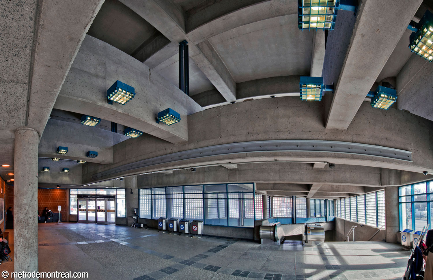 Inside the east headhouse, looking toward the stairs to the ticket hall. The triangular area around the stairs sits atop the main volume (crowning half of it), and is surrounded by glass block walls that admit sunlight.