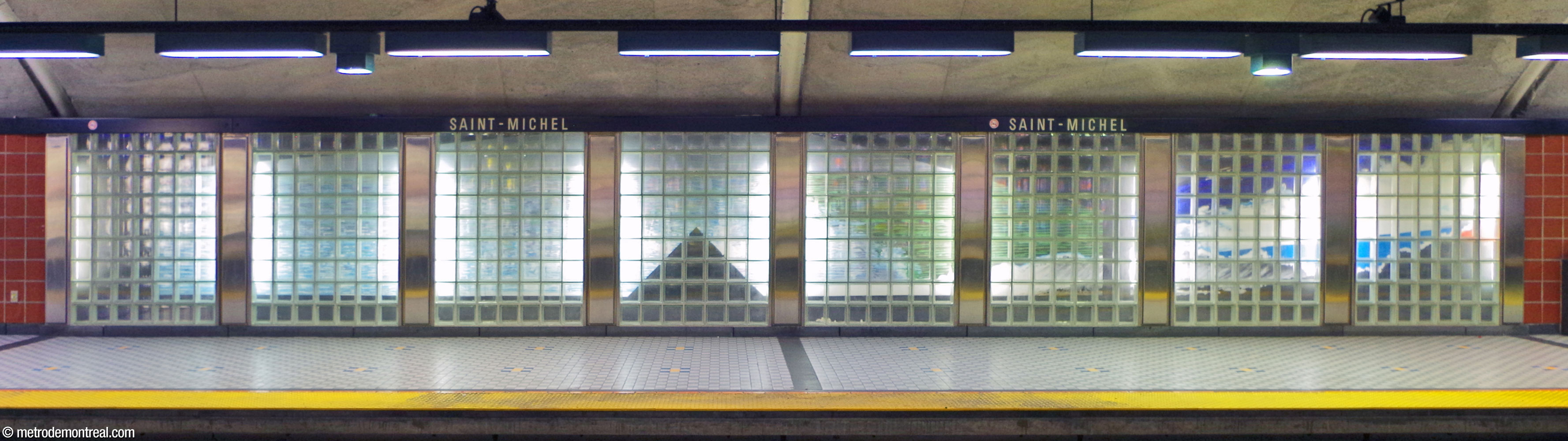 Mural by Lauréat Marois entitled Habitacle, located near the west end of the arrival platform, with a dark triangular form on a blue-green background.