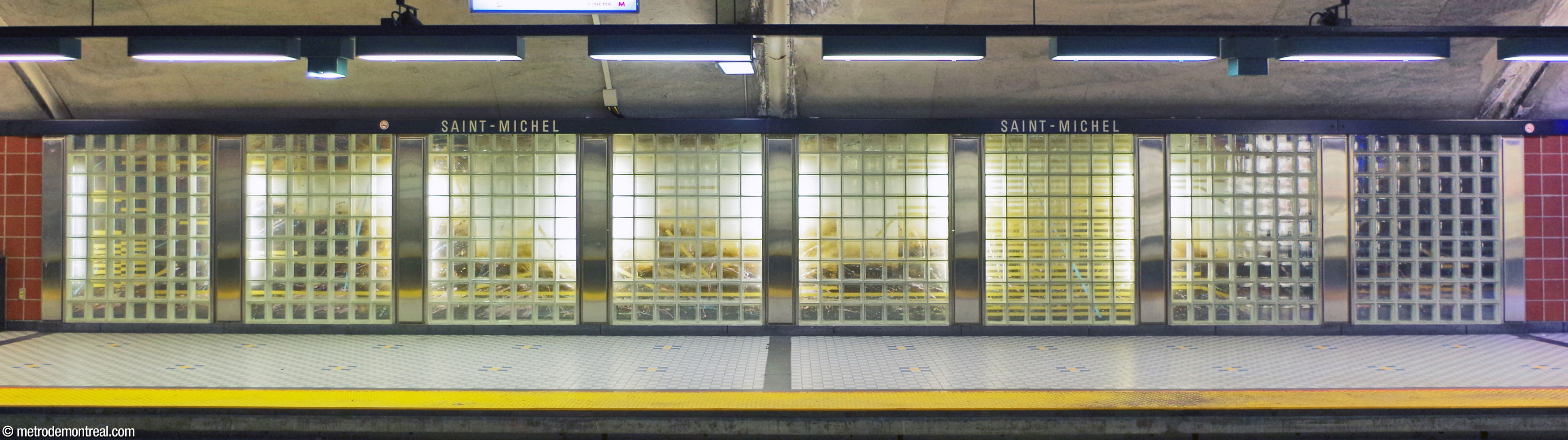 Mural by Normand Moffat, located on the arrival platform near the stairs, with abstract forms in yellow, tan, and brown.