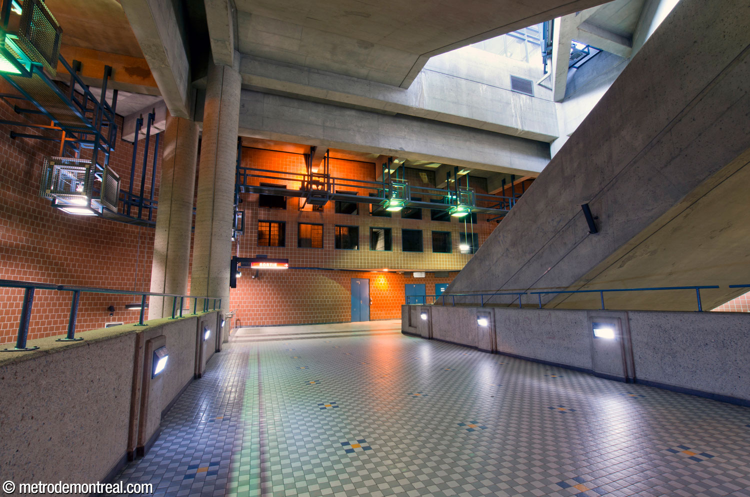 Looking along the bridge from the arrival platform landing toward the foot of the stairs to the ticket hall.