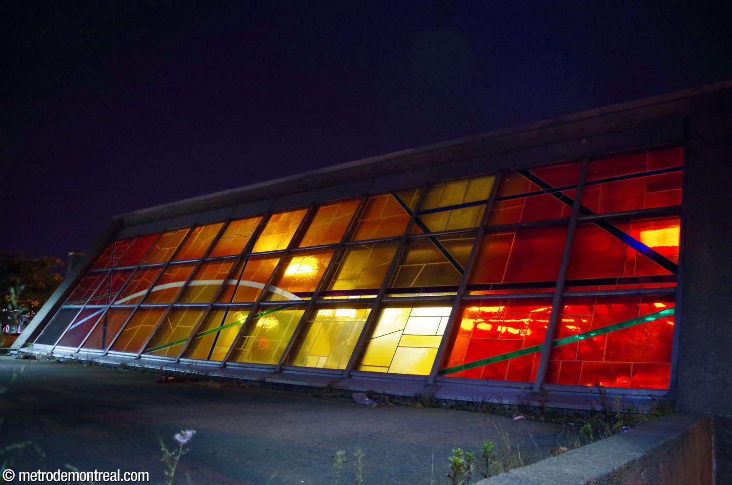 Exterior view of Marcelle Ferron's stained glass window at night.